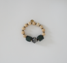 Green, cream, and black beaded bracelet.