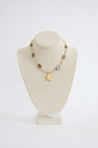 Cream and brown beaded necklace with gold star.