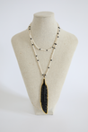 long necklace with large black feather