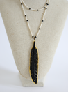 long necklace with large black feather